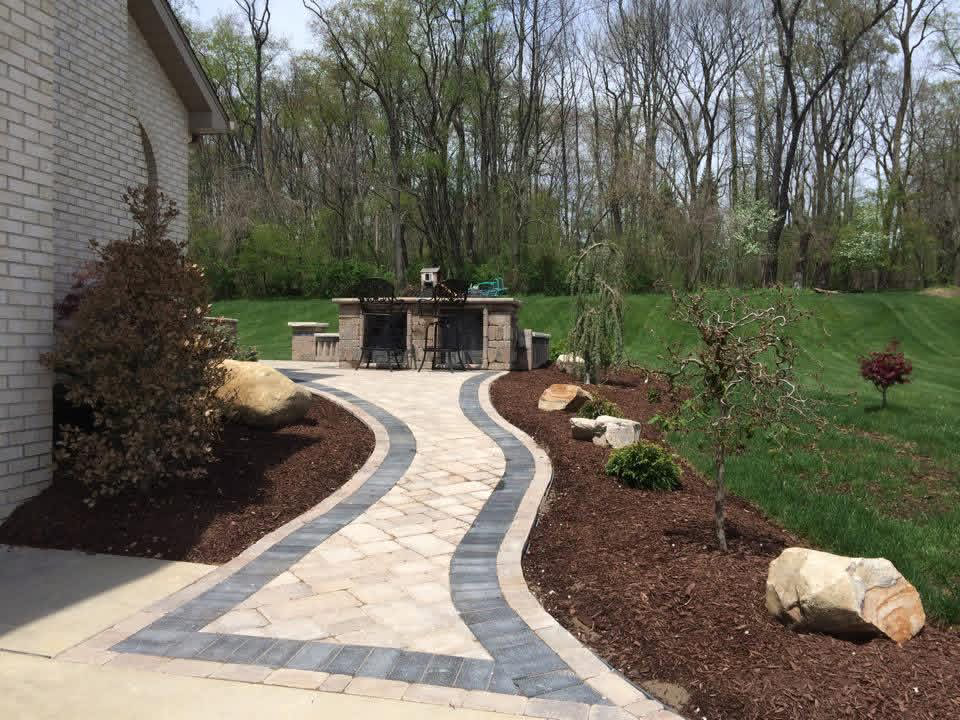 Curved paver pathway with stone accents
