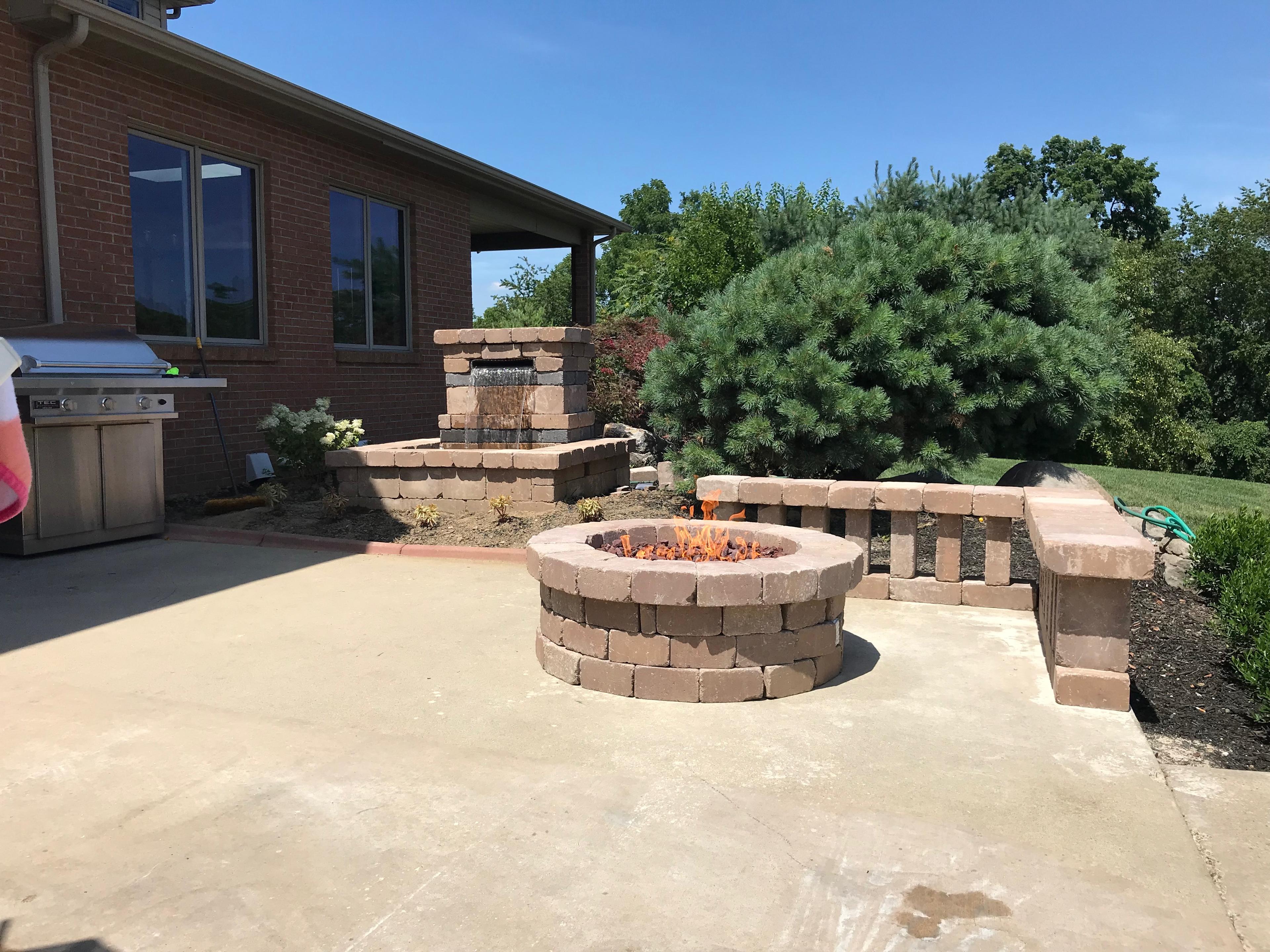 Composite patio with fire pit and stone seating walls